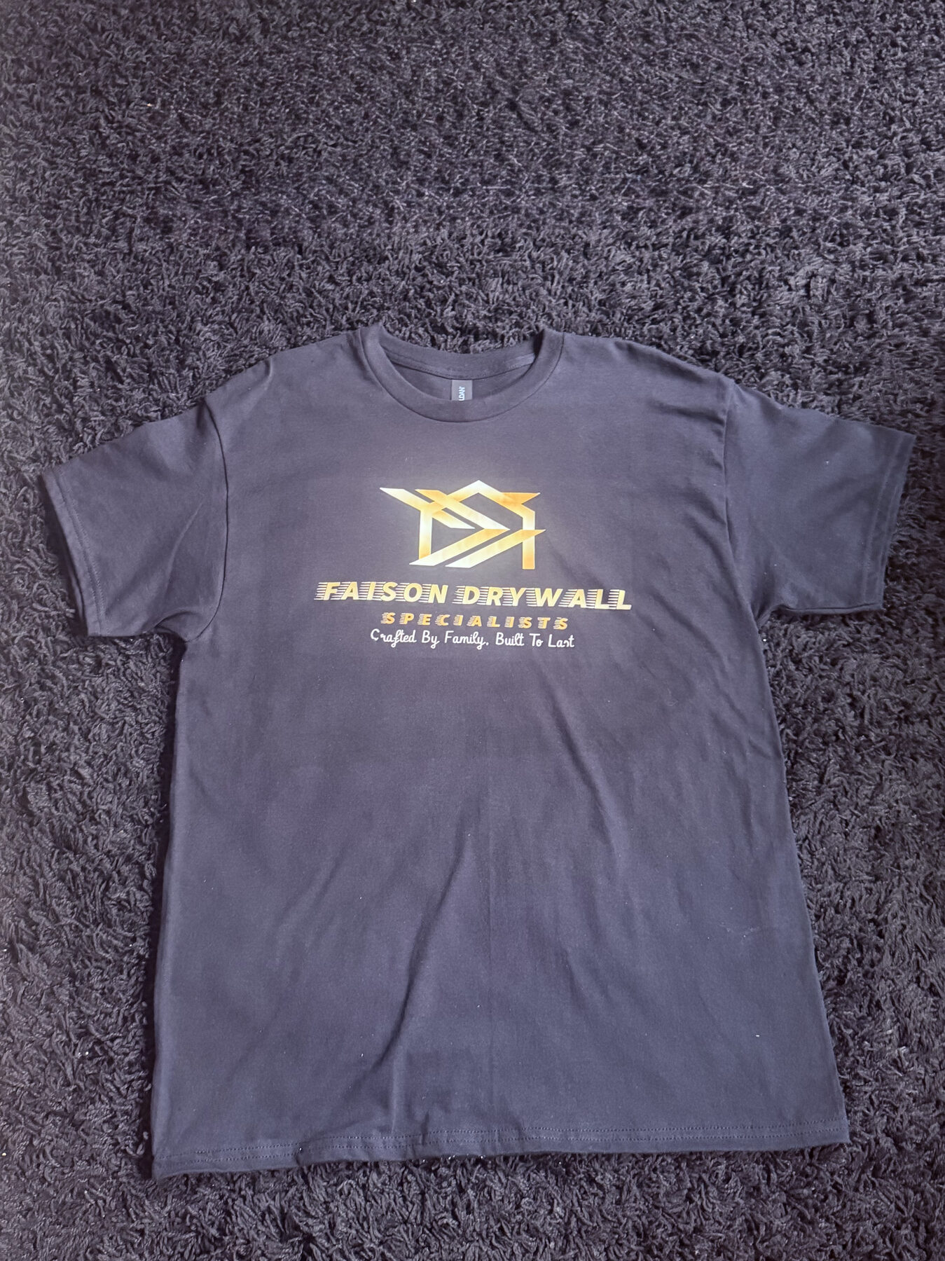 Faison Drywall crew member in grey work shirt
